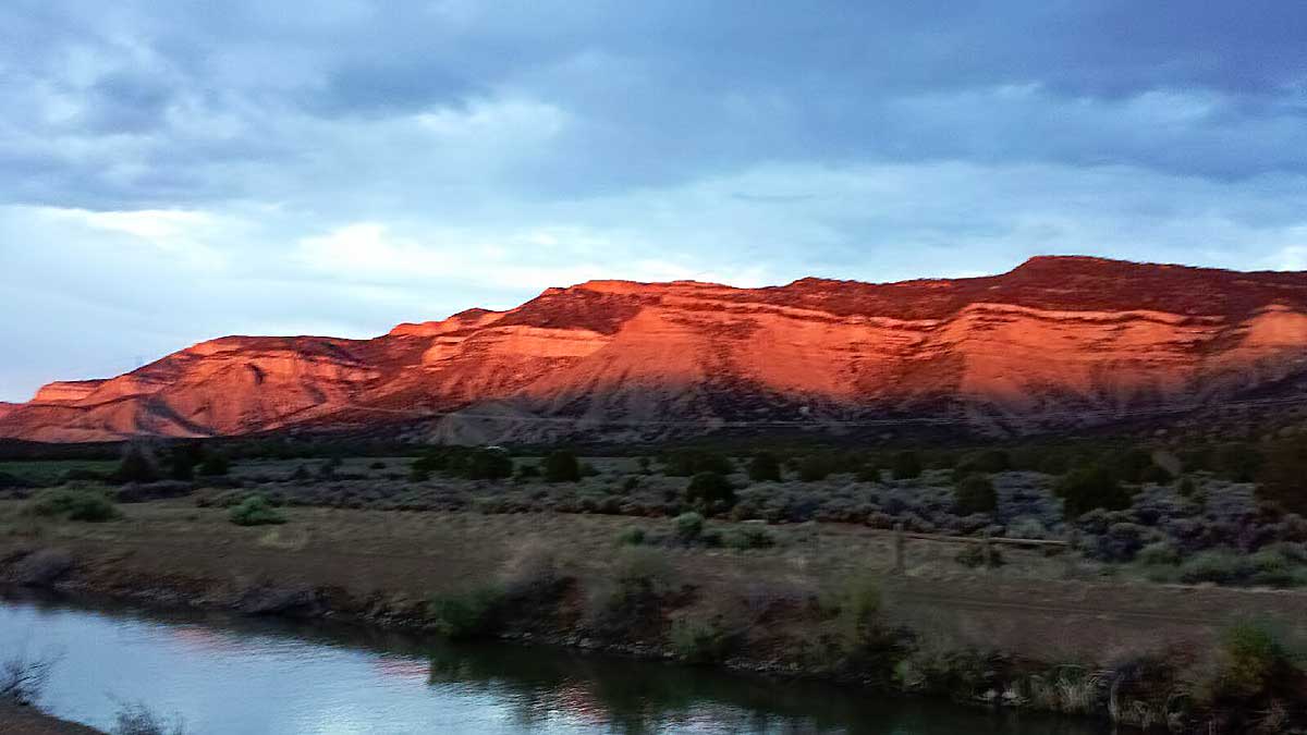 A red glow descends on the surrounding foothills at Grizzly Roadhouse B&B and Vacation Rentals